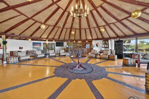 A spacious lobby with a high ceiling, a central chandelier, and a patterned floor. - PrideInn Mara Camp & Cottages (Maasai Mara)