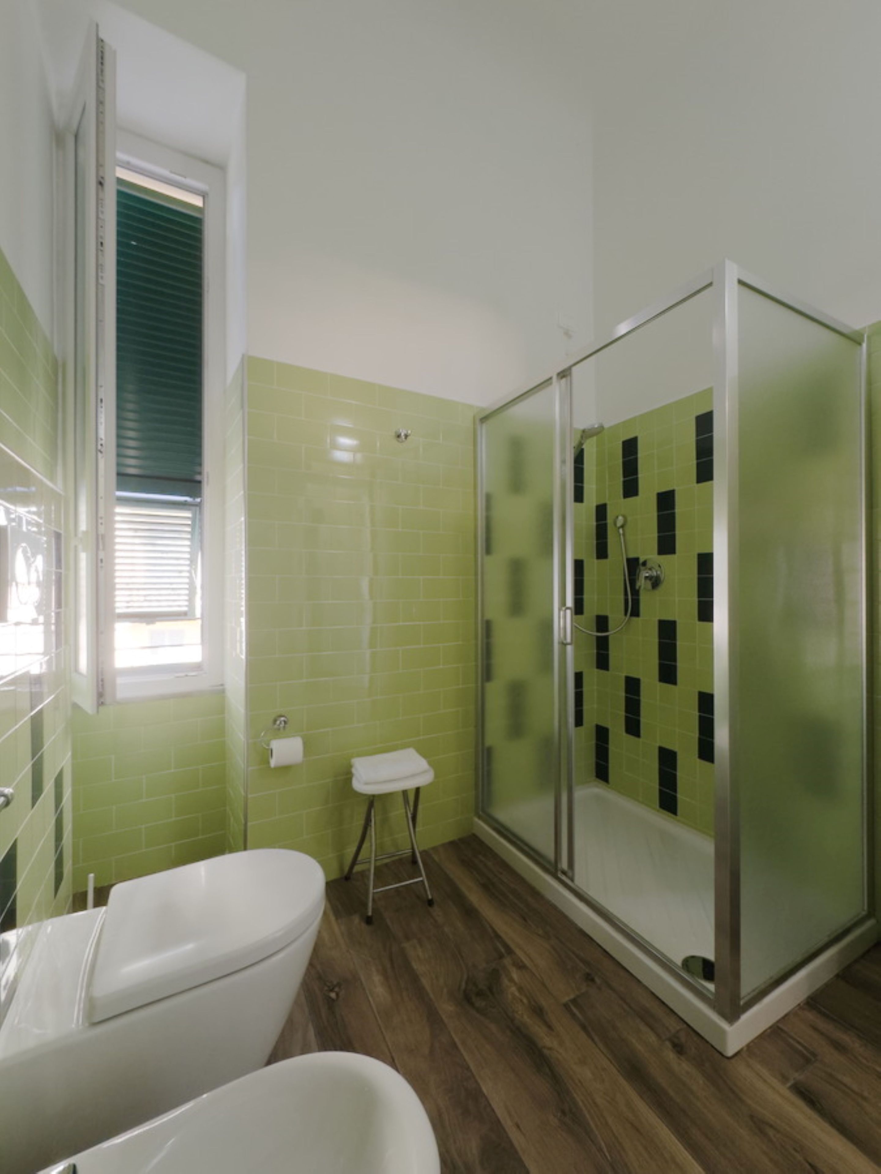A bathroom with a bathtub, a shower with a glass door, and a toilet.