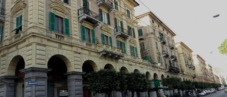 A historic building with multiple balconies and arched windows.