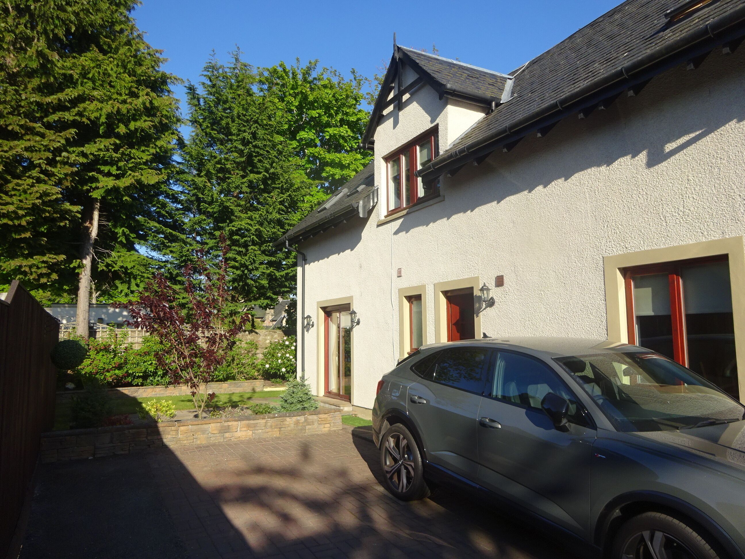 A house with a car parked in the driveway.