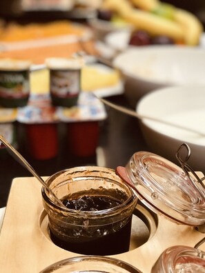 A buffet table with various food items and condiments. - Mak Albania Hotel (Tirana)