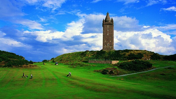 A historic tower on a hill with a golf course in the foreground. - Peartree Hill (Belfast)