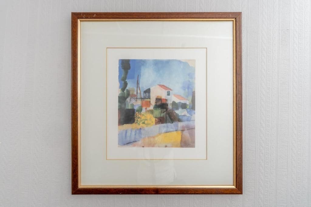 A framed artwork on a wall.
