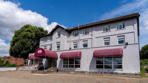 A two-story building with a flat roof, multiple windows, and a red awning over the entrance. - Norwich Central Hotel - Near Norwich Train Station & Carrow Road Stadium (Norwich)