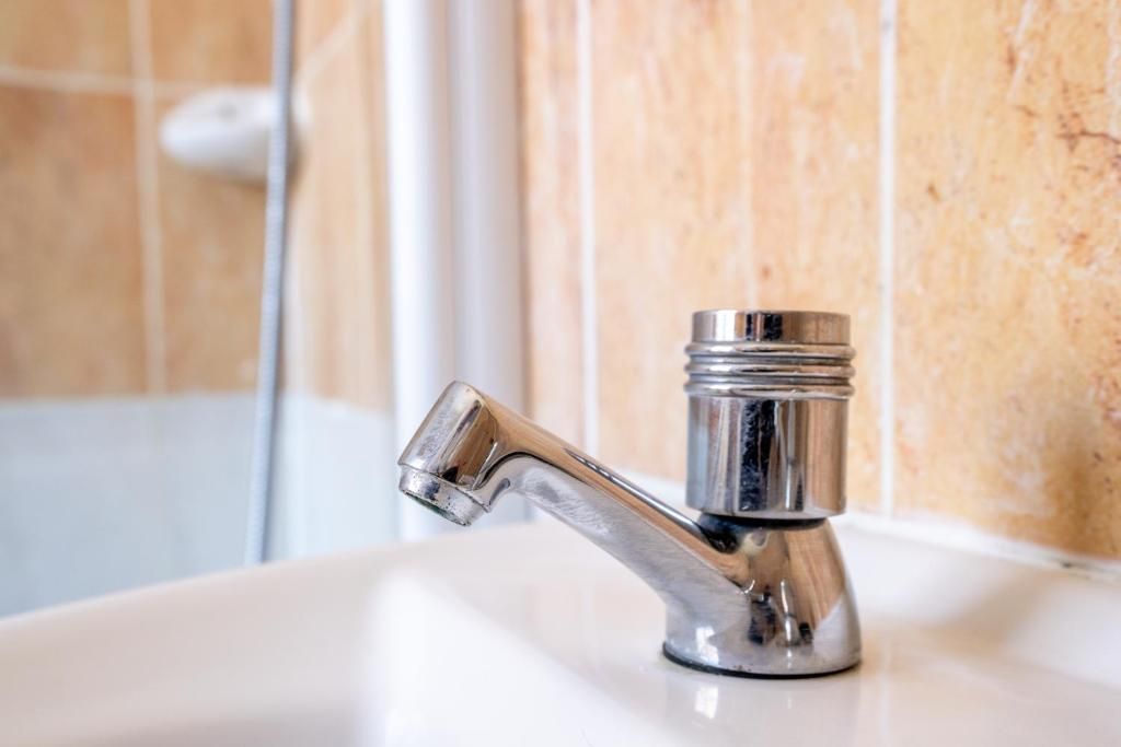 A bathroom sink with a chrome faucet.