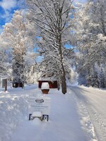 A snow-covered landscape with a sign for Geijerholms Herrgård Bed & Breakfast Hotel.