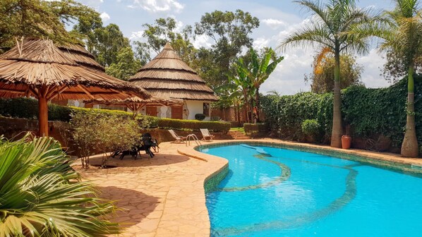 Una piscina al aire libre, tumbonas