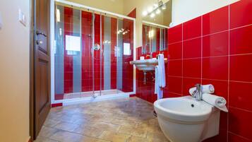 A bathroom with a shower, sink, and toilet.