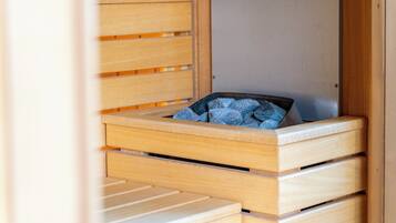 A wooden bed with a mattress and a blanket.