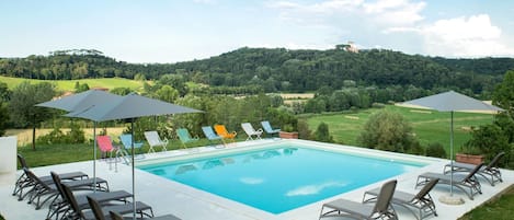 Seasonal outdoor pool, open 10:00 AM to 7:00 PM, pool umbrellas