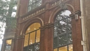 A building with arched windows and a sign reading "Reading Room & Library". - Urban Stay Shard View Apartments (London)