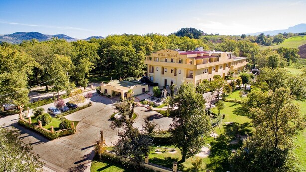 An aerial view of the Elia Hotel, featuring a central building with multiple balconies, surrounded by lush greenery and a well-maintained garden. - Elia Hotel (Buccino)