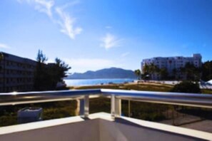 A view from a balcony overlooking a body of water with buildings in the background. - Venados Inn (Mazatlán)