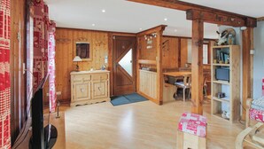 Un intérieur en bois, avec une porte en bois, un meuble en bois, une table en bois et une chaise en bois.