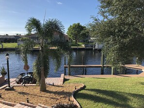 Enjoy serene lakeside views and stroll along the paved walkway to the dock, perfect for boating.