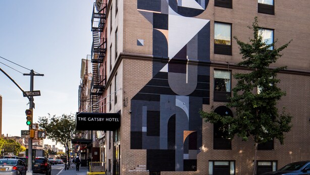 A building with a large, modern geometric design on its facade, labeled "The Gatsby Hotel." - The Gatsby Hotel (New York)
