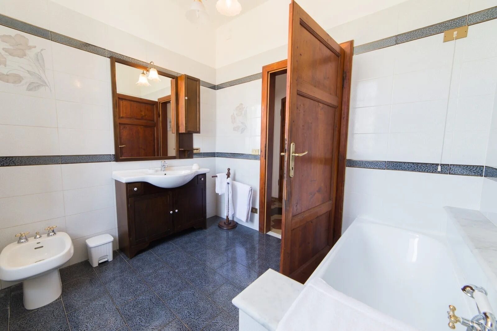 A bathroom with a bathtub, sink, and toilet.