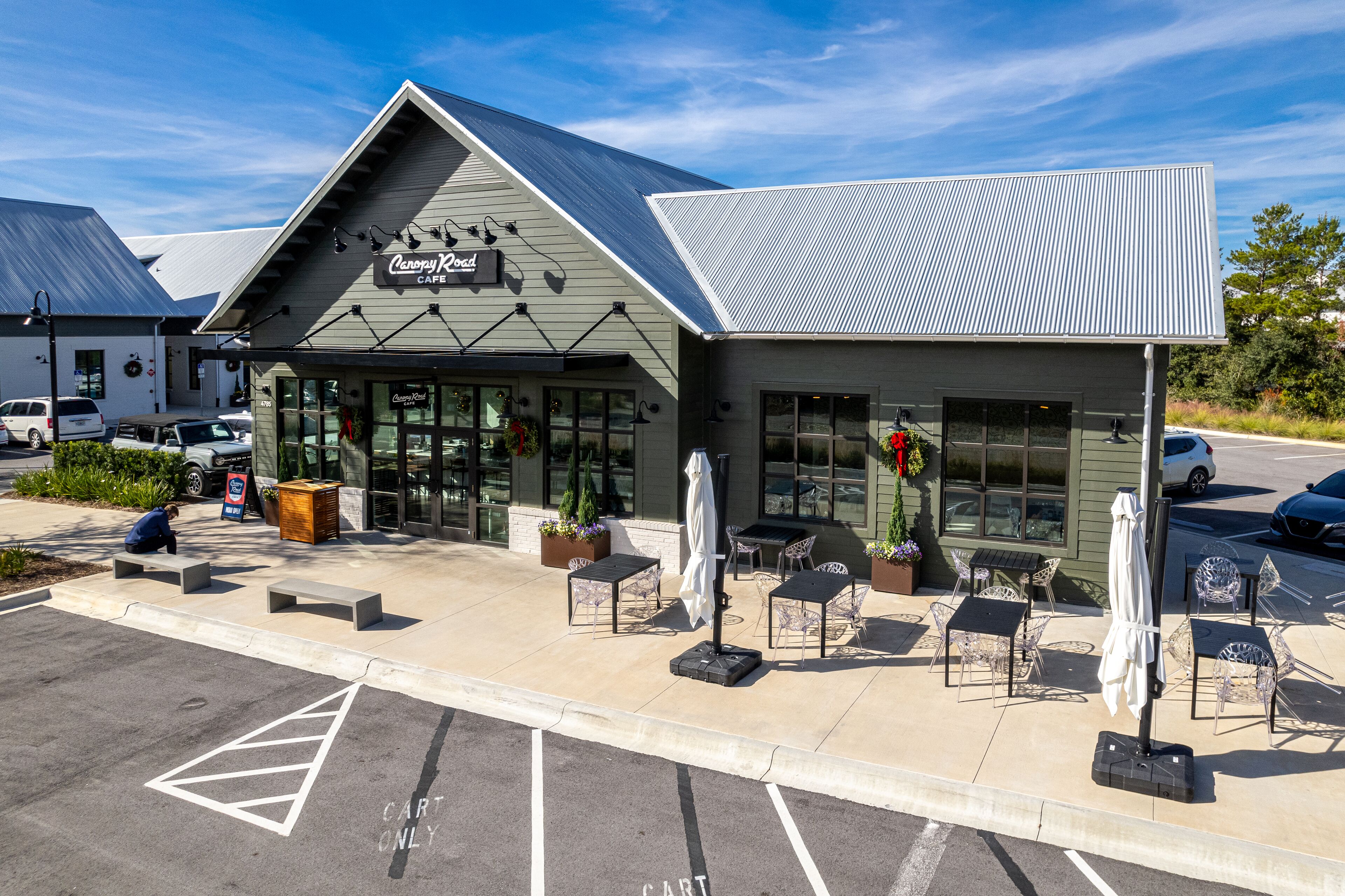 A cafe with outdoor seating and a covered patio area.