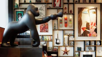 A modern interior with a large black sculpture, shelves with books and decorative items, and a star decoration.