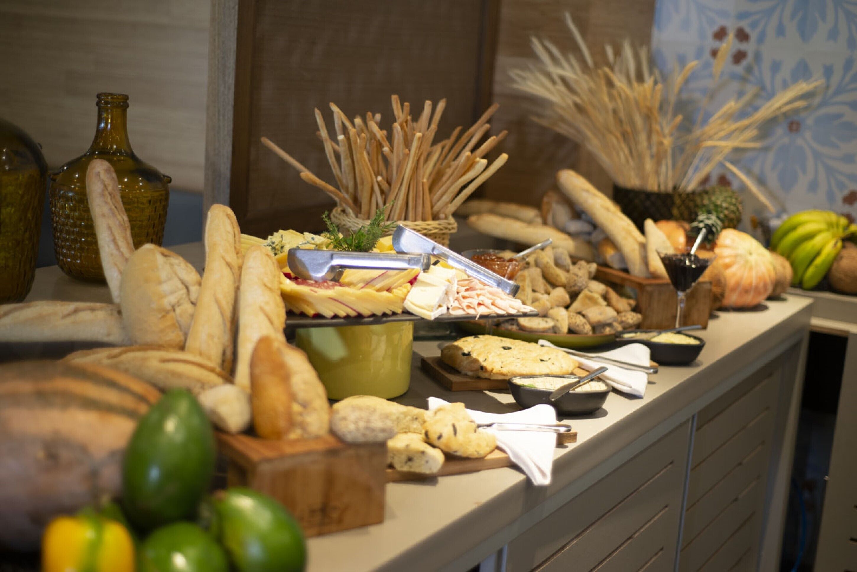 A buffet table with various food items and condiments.