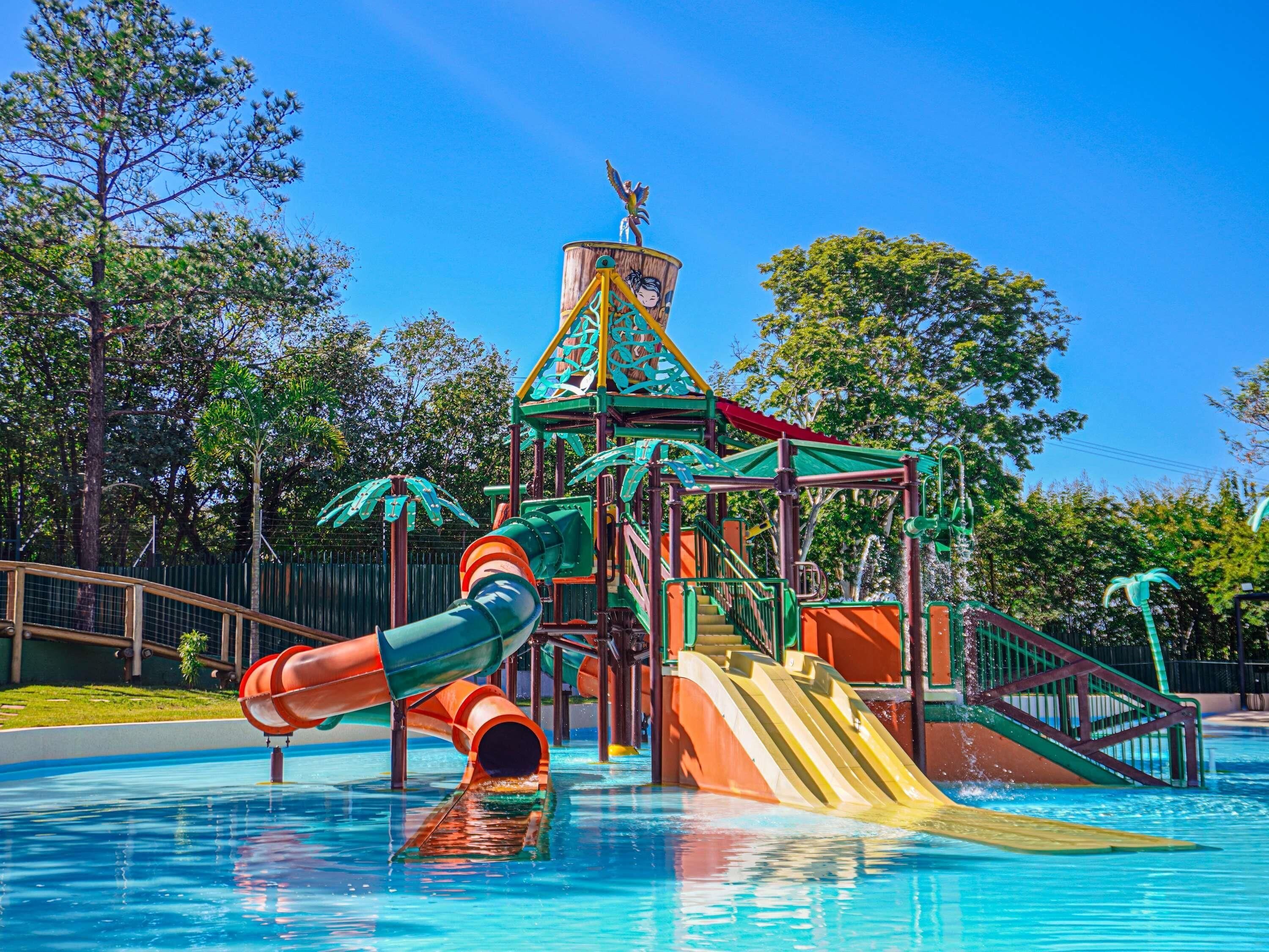 A water park play structure with slides and a climbing area.