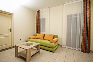 Apartment, 1 Bedroom, Balcony, Partial Sea View | Living area | Flat-screen TV