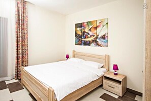 Apartment, 1 Bedroom, Sea View | 1 bedroom, desk, soundproofing, iron/ironing board