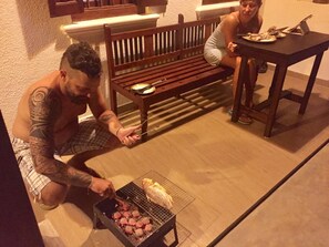 A man grilling sausages on a portable grill outdoors. - Natures Lodge-Galle (Galle)