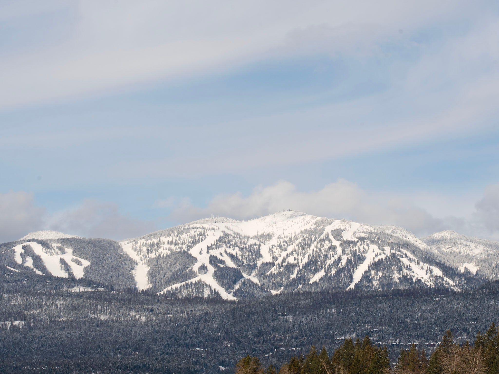 A snow-covered mountain range with a clear sky.