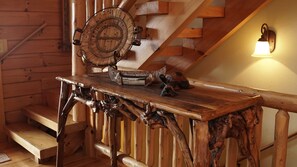 A wooden table with a woven basket and a small decorative item. - 3BR log cabin, Hot Tub, sleeps 9, exceptional view + free railroad tix (Bryson City)