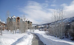 Winter scenery surrounds this traditional residential area with multi-story buildings and snow-covered roofs.