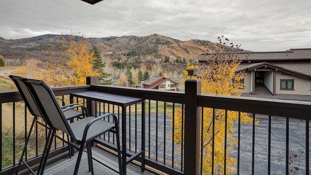 A balcony with a view of a mountainous landscape and autumn foliage. - RA517 | Nice Furnishings | Pool and Hot Tub Access | Winter Shuttle (Steamboat Springs)