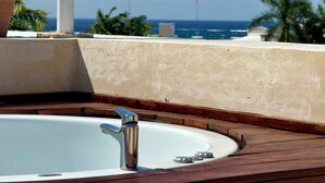 A hot tub with a view of the ocean and palm trees. - Trendy 2BED *Wi-fi High Speed-Private Jacuzzi-Steps the ocean (Playa del Carmen)