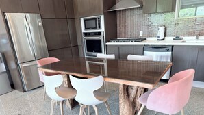 A modern kitchen with a stainless steel refrigerator, double oven, microwave, and gas stove. - Trendy 2BED *Wi-fi High Speed-Private Jacuzzi-Steps the ocean (Playa del Carmen)