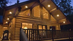 A log cabin with a balcony and large windows. - Sunrise Ridge - Free Train Tours + Cabin + Stunning Views/Deck + Close to (Bryson City)
