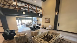 A spacious lobby with a foosball table, comfortable seating, and a staircase leading to an upper level. - River Run Village Walk To Gondola Pool Hot Tubs Restaurants and Shops DELUXE (Keystone)