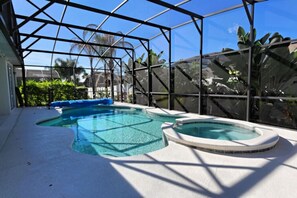 An indoor swimming pool with a glass ceiling, surrounded by tropical plants. - Rivendell: Private Pool/Spa with 24/7 Support! (Davenport)