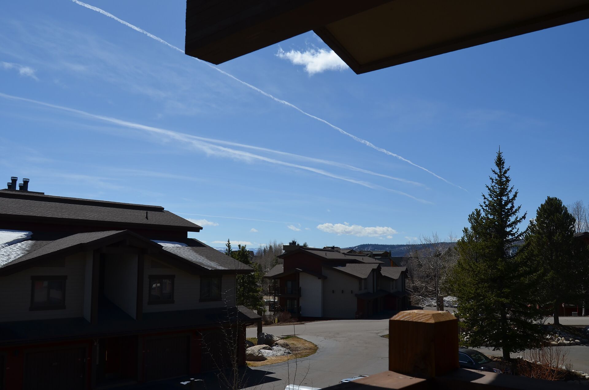 A residential area with houses, a clear sky, and a distant mountain range.