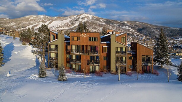A modern multi-story hotel with a ski resort backdrop, featuring balconies and large windows. - W3321 | Gorgeous Updated Condo | Pool | Walk to Mtn Village | Winter Shuttle (Steamboat Springs)