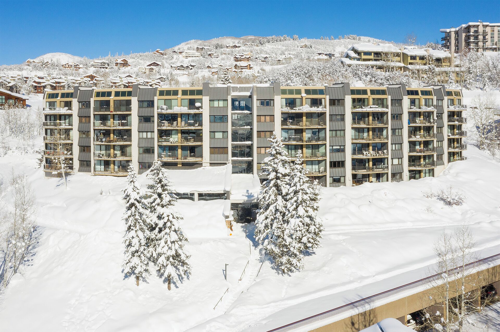 A multi-story hotel with a modern architectural design, featuring balconies on each floor.