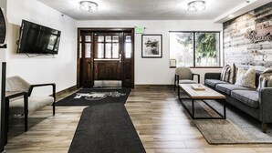 A modern living room with a sofa, coffee table, and a TV mounted on the wall. - Walk to Main Street/Town Lift I Hot Tub I Sauna I Managed by Park City Lodging (PARK CITY)