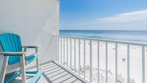 A balcony with a view of a beach.