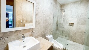A modern bathroom with a large mirror, a sink, and a glass-enclosed shower. - Trendy 2 Bedrooms + Near Mamita's Beach + Seps from 5th av- Playa del Carmen (Playa Del Carmen)