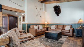 A cozy living room with a sofa set, a patterned armchair, and a coffee table.