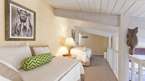 A cozy room with a bed, a nightstand, a lamp, and a framed picture on the wall. - SE076 | Mountainside Condo | View | Hot Tub | Winter Shuttle | Ski In/Out (Steamboat Springs)