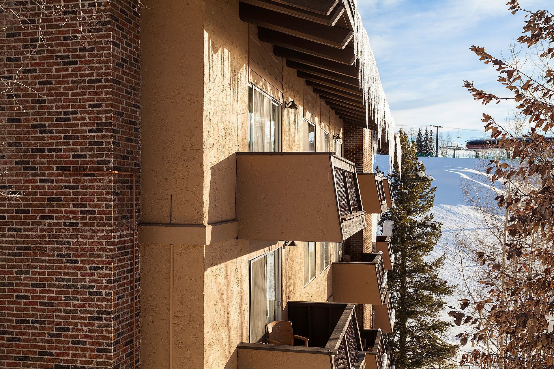 A multi-story building with a brick facade and balconies.