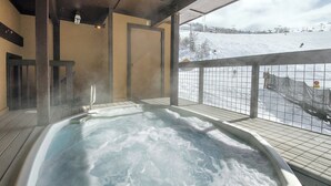 A hot tub with a view of a snowy ski slope. - SE076 | Mountainside Condo | View | Hot Tub | Winter Shuttle | Ski In/Out (Steamboat Springs)