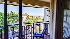 A balcony with a view of the ocean and palm trees. - Breathtaking Ocean Views, Steps to Coligny Plaza! (Hilton Head)