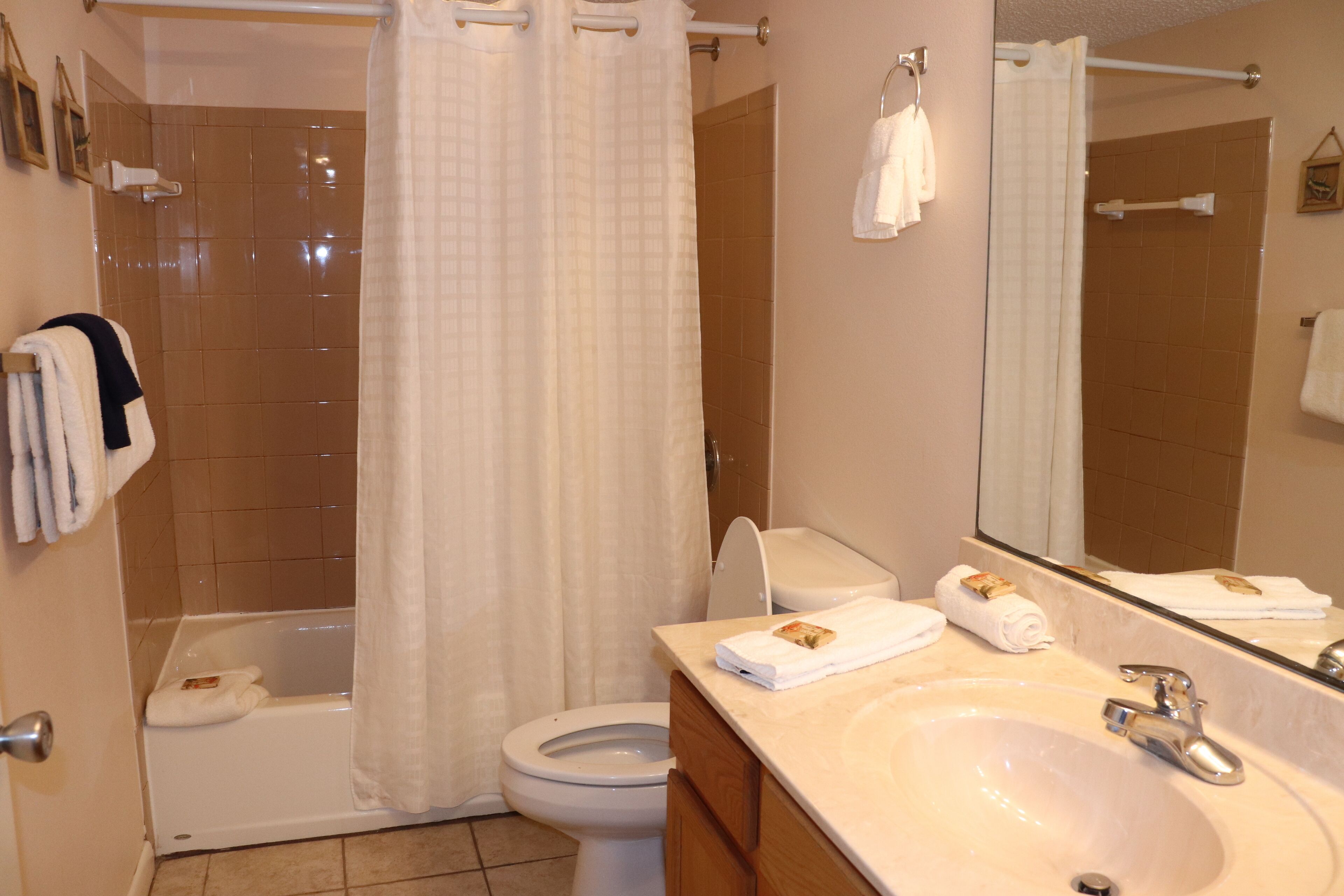 A bathroom with a bathtub, toilet, and sink.