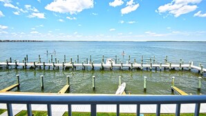 A pier extending into calm water with a clear sky. - Thunder Island 10A-Baywater 39th St, Pool, Elev, W/D, AC (Ocean City)
